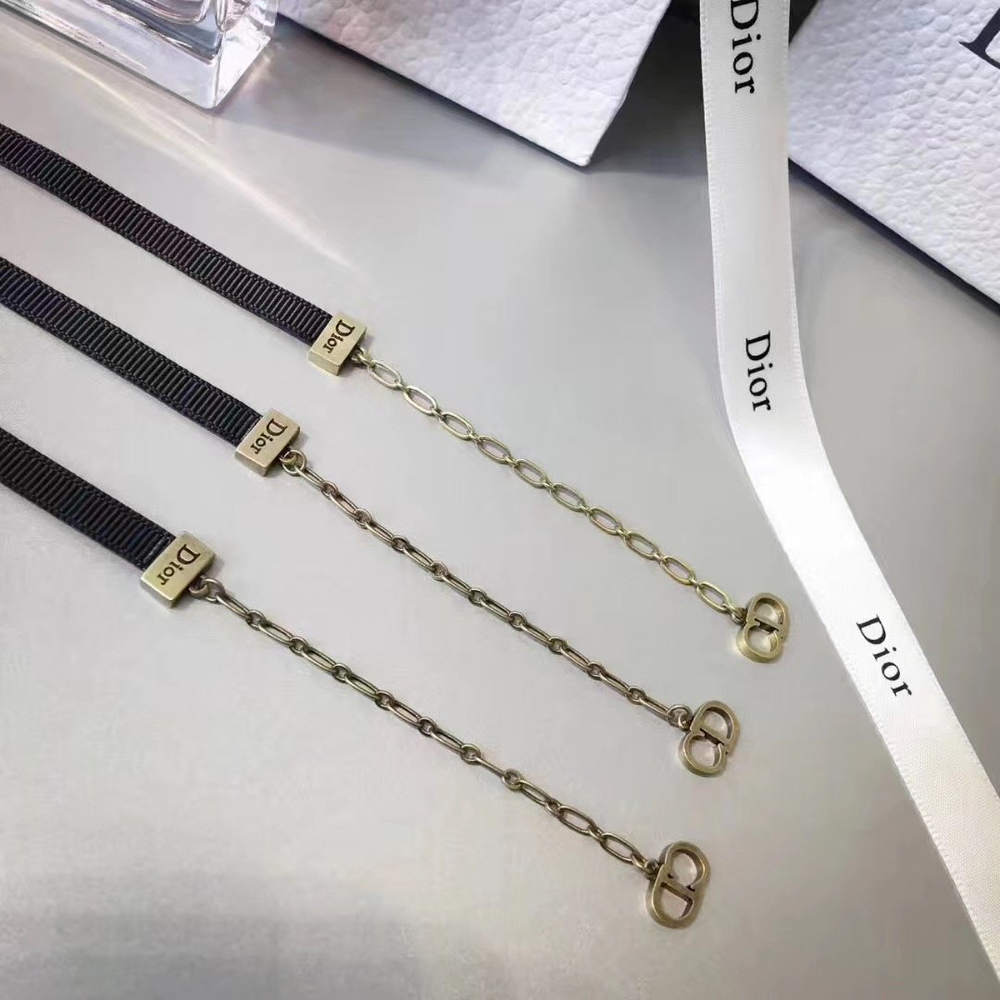 Choker necklace featuring a black grosgrain band and a gold-tone metal "D!0R" signature. - Image 2