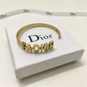Gold bracelet/Bangle with J@D!0R cut out.