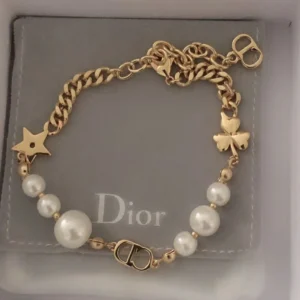 Alternative view of Linked chain gold Bracelet with CD cutout, clover leaf motif and white pearls.