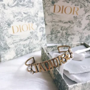 Alternative view of Gold bracelet/Bangle with J@D!0R cut out and pearls.