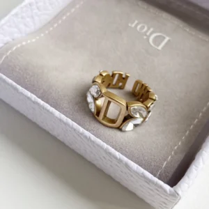 Gold ring with gems and D engraved on it.