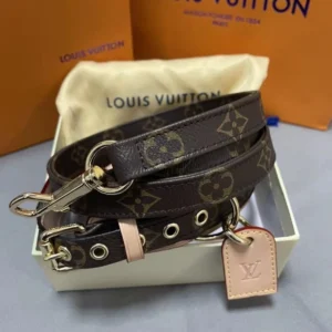 Dog leash made of dark brown cowhide with golden hardware.