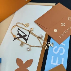 Alternative view of Linked chain bracelet with metallic charms and pearls.