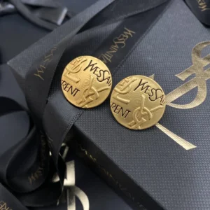 Alternative view of 18K gold plated Y$L branding on circular vintage coin like earrings.
