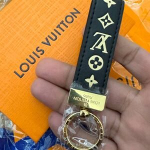 Keychain with golden hardware and leather charm.