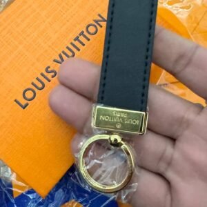 Alternative view of Keychain with golden hardware and leather charm.